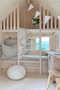 a bedroom with wooden walls and flooring next to a bed in a loft style room