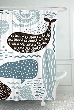 a bathroom with a shower curtain that has whale designs on it