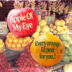 an advertisement for apple of my eye with oranges and other fruit in the background