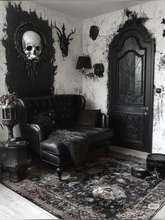 a black and white living room with skulls on the wall, leather couches and rugs