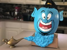 a blue pumpkin sitting on top of a counter