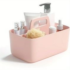 a pink caddy with soap, lotion and other items in it on a white surface