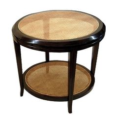 a round table with two shelves on each side and wicker inlays at the top