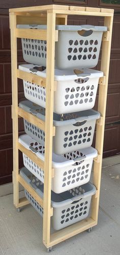 three white baskets stacked on top of each other in front of a brown garage door