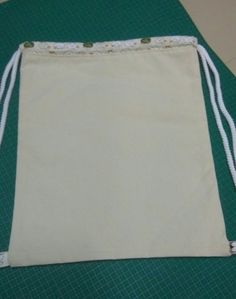 a white bag sitting on top of a green mat