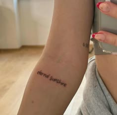 a woman with a tattoo on her arm saying, everyone is fine enough to survive