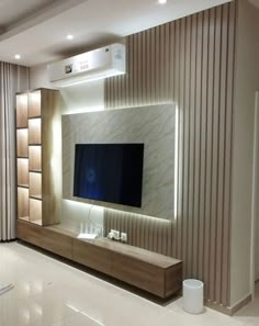 a living room with a flat screen tv mounted on the wall