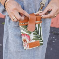 a woman is holding her purse with both hands