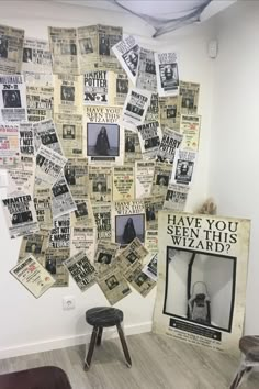 a room with several pieces of newspaper on the wall and a chair in front of it