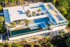 an aerial view of a house surrounded by trees