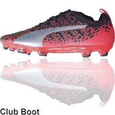 a pair of soccer cleats with red and black design on the soles