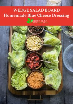 a wooden tray topped with lettuce and other foods