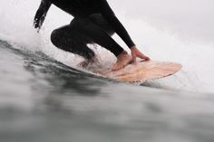 a person riding a surf board on a wave in the ocean with their feet up