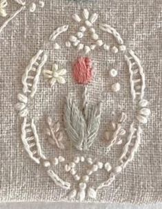 a close up of a piece of cloth with flowers and leaves in the center on it