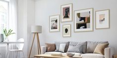 a living room filled with furniture and pictures on the wall above it's coffee table