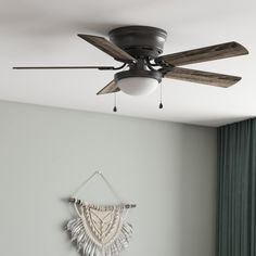 a ceiling fan mounted to the side of a wall