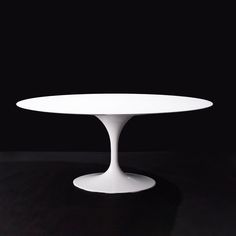 an oval white table on a black background