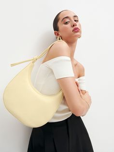 Hold me. Shop the Medium Rosetta Shoulder Bag from Reformation, a crescent shaped leather shoulder bag with a decorative tie detail and magnetic closure. Shoulder Bag Photoshoot, Dress Ungu, Bag Shoot, Bag Photoshoot, Night Fits, Shooting Bags, Lip Balm Collection, Sustainable Bag, Color Trends Fashion