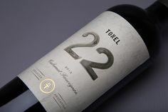 a bottle of wine with the number twenty two on it's side and an empty bottle next to it