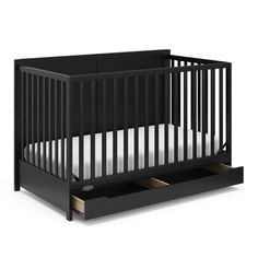 a black crib with two drawers on the bottom and an open drawer underneath it