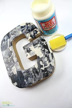 the letter e is made out of old photos and other crafting supplies such as paint, glue, and paper