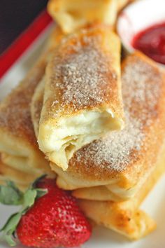 several pastries on a plate with powdered sugar sprinkled on top,