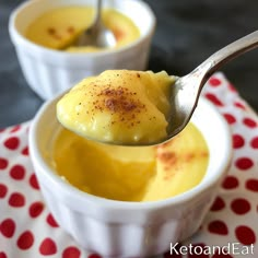 two small bowls filled with pudding on top of a red and white table cloth