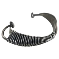 This modernist sculptural piece is one of Wiener's first creations as a jeweler-artist, in New York City, circa 1954.This cuff bracelet is composed of two simple aerodynamic pieces with sinuous curved shapes wrapped by an infinite wire, which in turn recreates a sculpture with constructivism patterns,, Stunning iconic piece of modernist jewelry.. Has a weight of 34.6 grams and fit a wrist up to 7 inches. Contemporary Metal Cuff Bracelet, Modern Adjustable Oxidized Bracelet, Modern Adjustable Oxidized Bracelets, Modern Cuff Bracelet With Oxidized Finish, Modern Adjustable Bracelets With Oxidized Finish, Modern Hand Forged Metal Bracelet, Modern Oxidized Finish Cuff Bracelet Bangle, Modern Oxidized Finish Cuff Bangle Bracelet, Modern Oxidized Cuff Bracelet Bangle