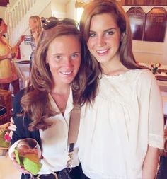 two women standing next to each other at a party