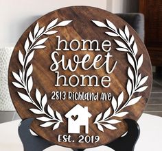 a wooden plaque with the words home sweet home on it