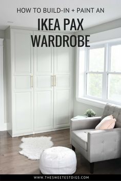 a living room filled with furniture and white cupboards next to a large window on top of a hard wood floor