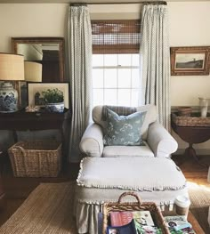 a living room with a chair, ottoman and pictures hanging on the wall above it