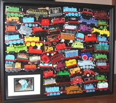 there is a framed picture with many toy trains on it