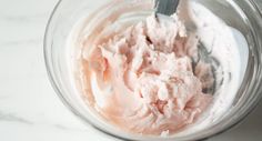 a bowl filled with whipped cream on top of a white counter