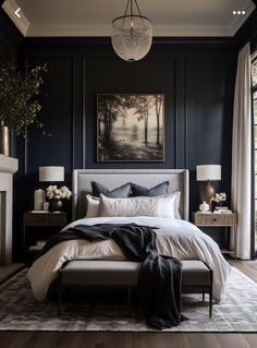 a bedroom with dark blue walls and white bedding is pictured in this image, it has