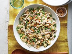 a white bowl filled with pasta and peas