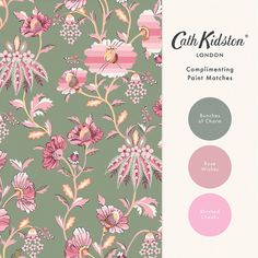 a green and pink wallpaper with flowers on it