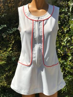 Here is a vintage 1970s White polyester tennis dress.Made by Haymaker Lacoste .No size tag.Measurements are as follows.Bust 36"  waist 34",hips 42",Length. Measured from top of shoulder to bottom 29".Zips up the front. Coral piping around sides.In nice vintage condition.If you live overseas please  me me for mailing cost.Price listed is USA only. Please take special note of measurements. 1970s sizing was much smaller than today's standards. Tennis dresses were very short not like a regular dress. So please take special note of length Lacoste Tennis Dress, Lacoste Tennis, Tennis Dresses, Womens Sports, Tennis Dress, Vintage 1970s, Sports Women, Sport Fitness, Size Tag