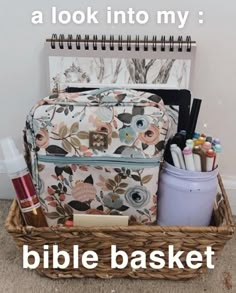 a basket filled with pens, pencils and other items next to a notepad