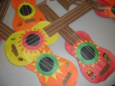 colorful paper guitars are arranged on the floor