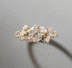 a three stone diamond ring sitting on top of a table