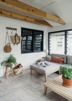 a living room filled with furniture and plants