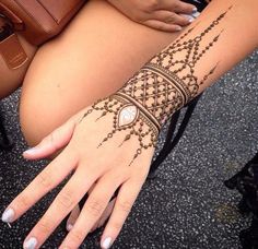 a woman's hand with henna on it