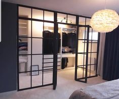 a bedroom with mirrored doors and closets in it