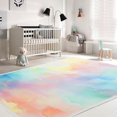 a child's room with a large rug in pastel colors