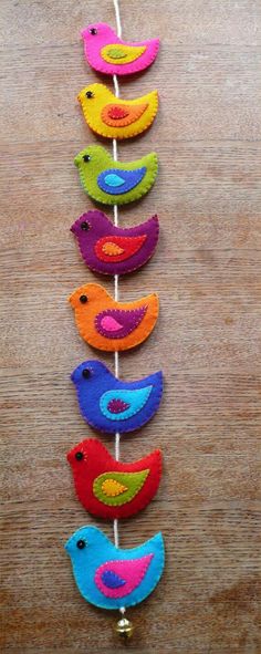 colorful felt birds are hanging on a string