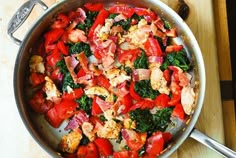 a pan filled with meat and vegetables on top of a wooden table