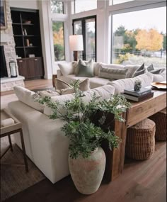 a living room filled with furniture and a large window