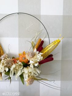 a wreath with flowers and corn on the cob