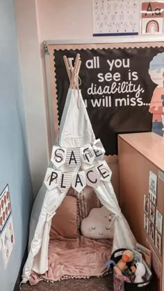 a child's teepee tent with the words safe place on it in front of a chalkboard